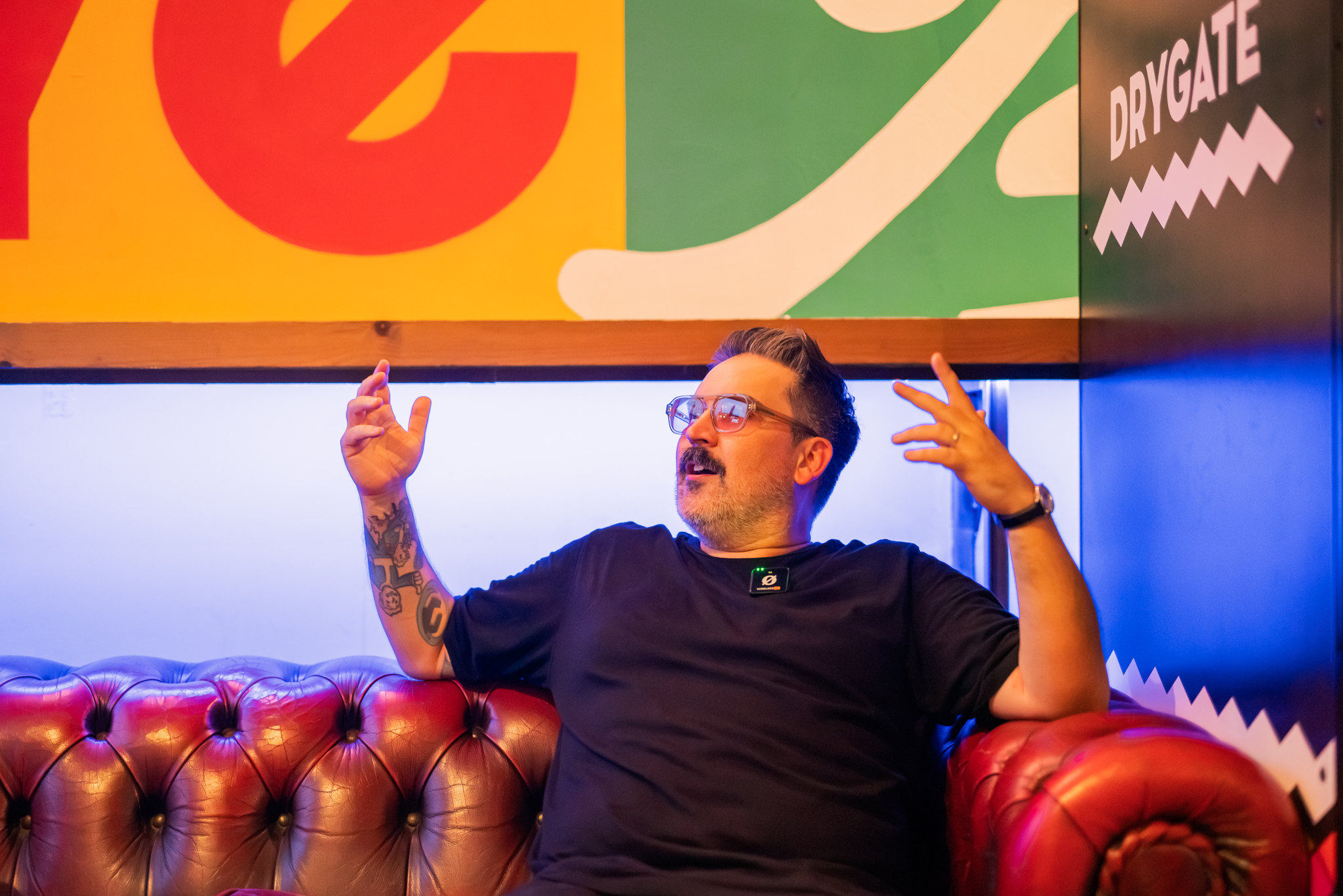Gary on a red leather sofa at Drygate, mid-story